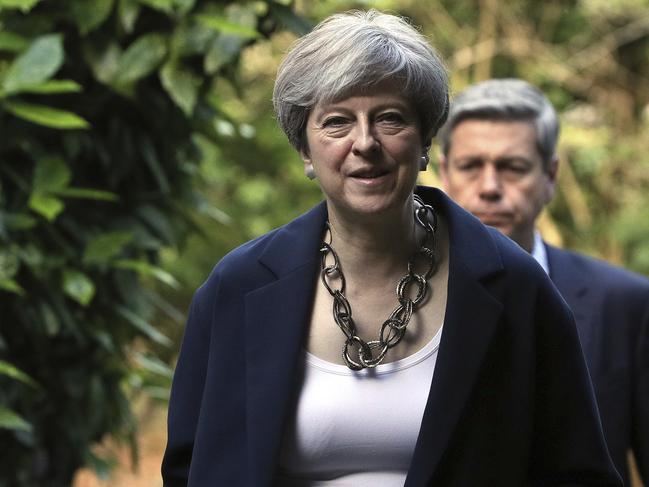 Britain's Prime Minister Theresa May arrives to attend Holy Communion at St Andrew's Church in Sonning, Berkshire, England, Sunday, June 11, 2017. May is under pressure after the Conservatives lost their parliamentary majority in Thursday's election. (Jonathan Brady/PA Wire(/PA via AP)