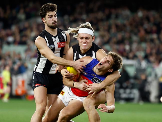 Darcy Moore catches Zac Bailey high. Picture: Michael Willson/AFL Photos via Getty Images