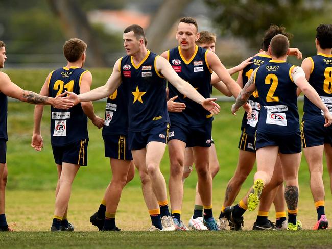 George Romios of Essendon Doutta Stars is congratulated by team mates after kicking a goal during the round 16 Strathmore Community Bank Premier Division match between Essendon Doutta Stars and Maribyrnong Park at Nipper Jordan Oval in Essendon, Victoria on August 12, 2023. (Photo by Josh Chadwick)