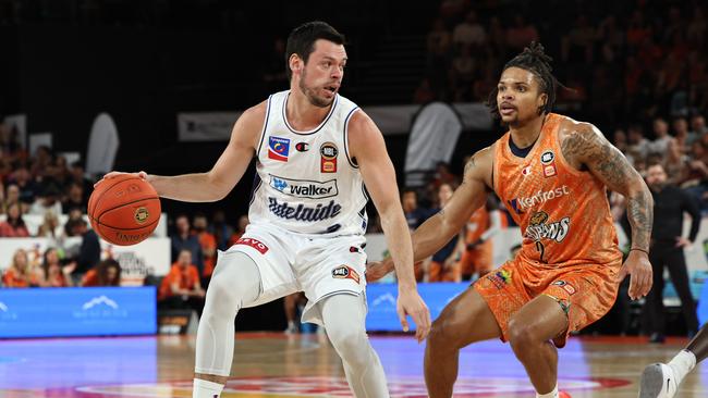 Adelaide's Jason Cadee looks for a way past Rob Edwards in the National Basketball League (NBL) match between the Cairns Taipans and the Adelaide 36ers, held at the Cairns Convention Centre. Picture: Brendan Radke