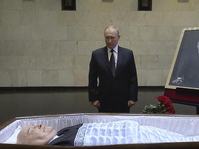 In this image taken from video provided by the Russian pool television on Thursday, Sept. 1, 2022, Russian President Vladimir Putin pays his last respect near the coffin of former Soviet President Mikhail Gorbachev at the Central Clinical Hospital in Moscow Russia. (Russian pool via Reuters)