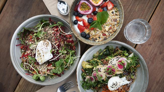 Breakfast at the Three Blue Ducks Ewingsdale, Byron Bay: Raw breakfast plate, sprouts, dates, beets and poached egg (left); Maple toasted muesli with honey, yoghurt and berries (top); Farm greens, kimchi, pickles and poached egg (right). Picture: Dylan Robinson