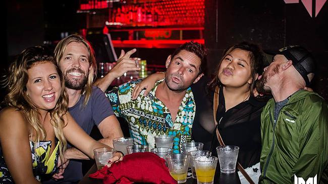 Foo Fighters drummer Taylor Hawkins and entourage Tim Fly (middle) and Steve (right) at Shooters Nightclub with residents Shylah Gibb (left) and Jess Joaquin (right).