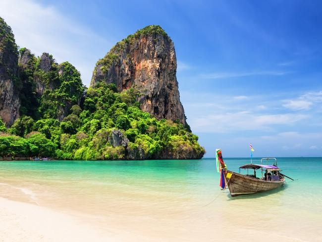 Traditional Thail longtail boats at picturesque Railay Beach.