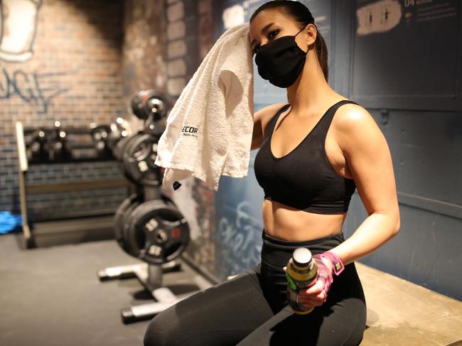 A woman wears a protective face mask at a gym in Cologne. Picture: Getty Images