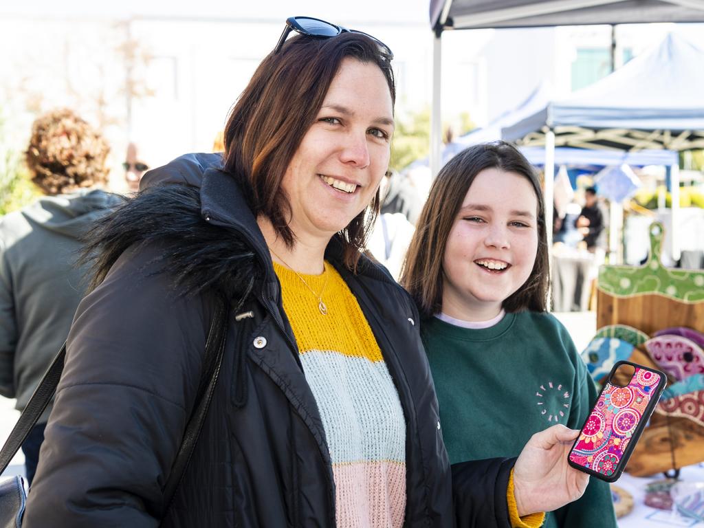 Nilisa Allen and daughter Ayla Allen check out Vibrant Connection Designs products at the NAIDOC arts and craft market at Grand Central, Saturday, July 9, 2022. Picture: Kevin Farmer