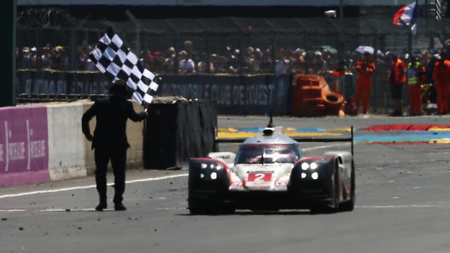 LE MANS, FRANCE — JUNE 18: The overall winning The Porsche LMP Team 919 of Earl Bamber, Timo Bernhard and Brendon Hartley cross the finish line to win the Le Mans 24 Hours race at the Circuit de la Sarthe on June 18, 2017 in Le Mans, France. (Photo by Ker Robertson/Getty Images)