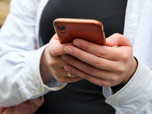 SYDNEY, AUSTRALIA - Newswire Photos - JULY 25 2023: People are seen on their mobile phones during lunch time in the Sydney CBD. Picture: NCA Newswire / Gaye Gerard