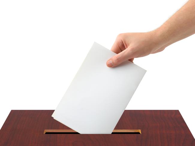 Thinkstock generic image of hand voting, putting piece of white paper into ballot box.