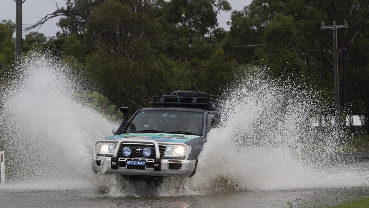 A car drives through flood waters on March 20, 2021 in Pitt Town, Australia. Picture: Brook Mitchell/Getty Images