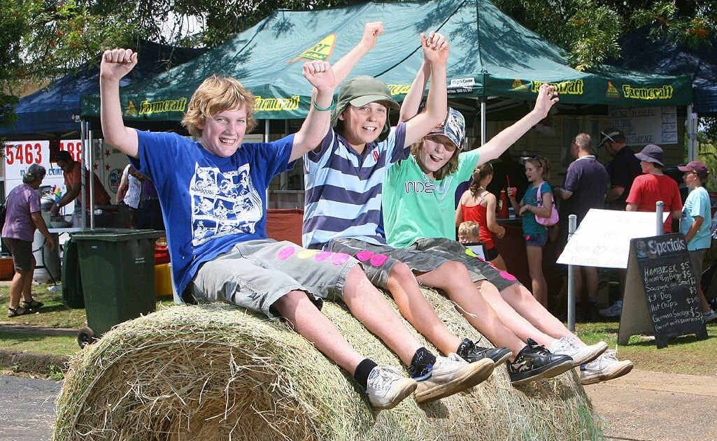 Thomas Yarrow, Steven Miller and Windston Olive perch precariously on one of the many bales of hay decorating Kalbar town on the weekend.