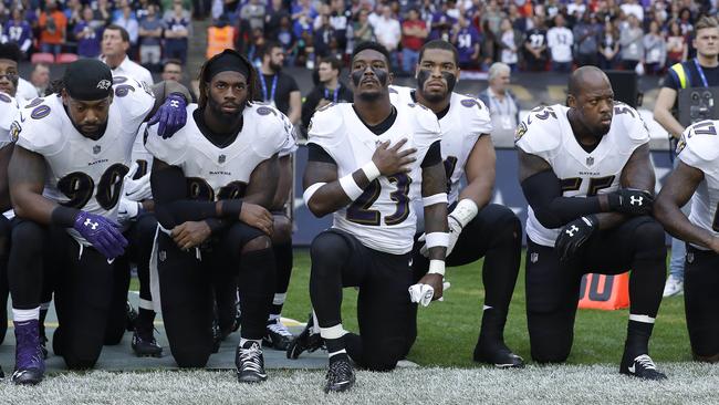 Baltimore Ravens players kneeling together. Pic: AP