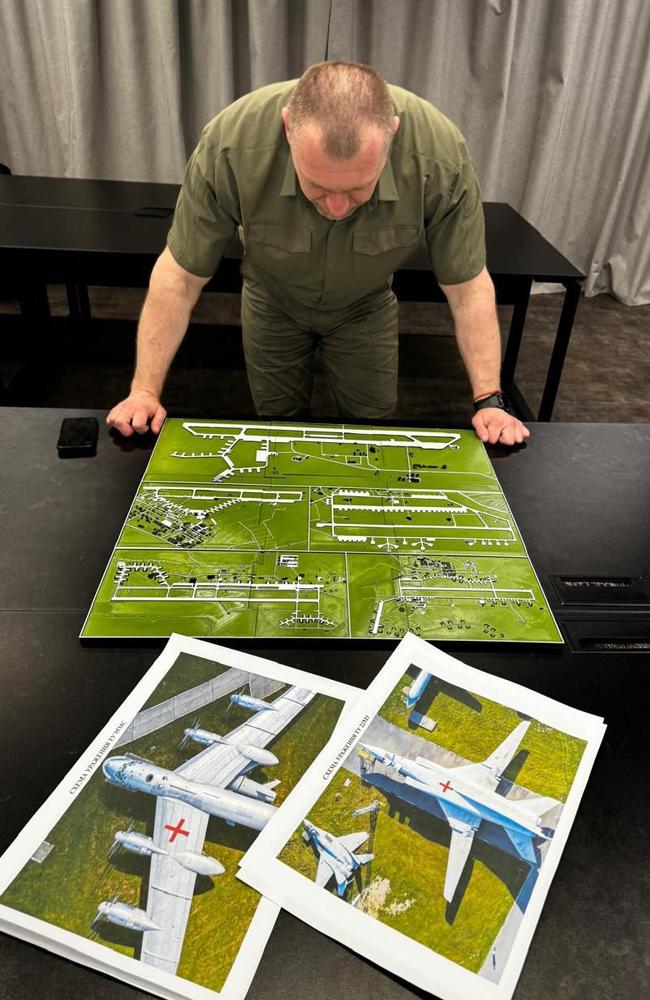 Head of Ukraine’s Security Service Vasyl Malyuk looking at a map showing a Russian military aircraft base. Picture: Handout / SECURITY SERVICE OF UKRAINE / AFP