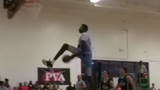 Bol Bol on his way to a sweet between-the-legs dunk.