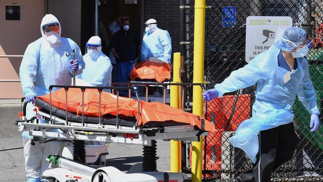 Medical staff move bodies from the Wyckoff Heights Medical Center to a refrigerated truck. Picture: AFP.