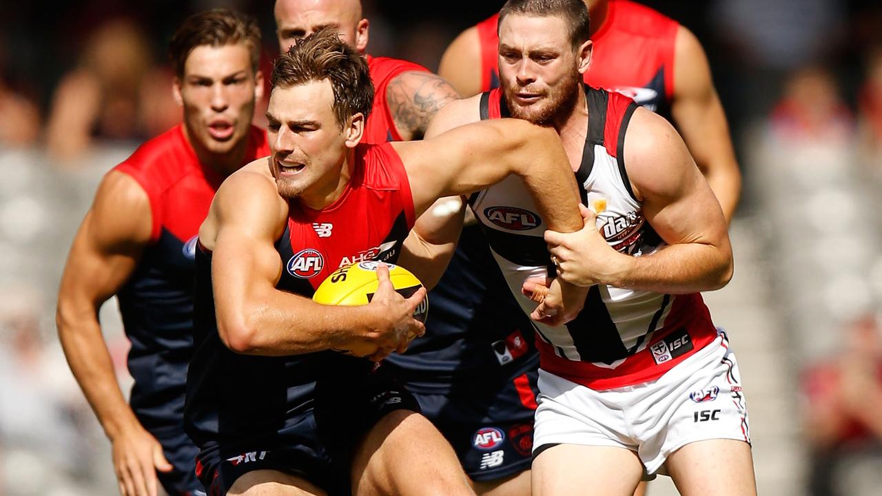 MELBOURNE, AUSTRALIA - MARCH 13: Dom Tyson of the Demons is tackled by Jack Steven of the Saints during the 2016 NAB Challenge match between the Melbourne Demons and the St Kilda Saints at Etihad Stadium, Melbourne on March 13, 2016. (Photo by Michael Willson/AFL Media/Getty Images)