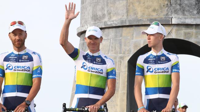 Stuart O'Grady (centre) waves alongside Svein Tuft (left) and Cameron Meyery at the 2013 Tour de France team presentation.