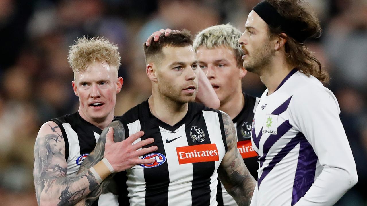 Jamie Elliott celebrates a goal with John Noble and Jack Ginnivan against Fremantle. Picture: Dylan Burns/AFL Photos via Getty Images