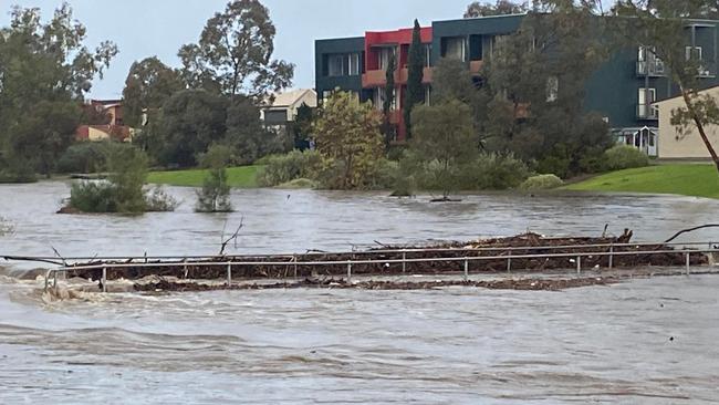 A bridge at Mawson Lakes connecting two school campuses is engulfed in water amid Monday's torrential downpour. Picture: Supplied