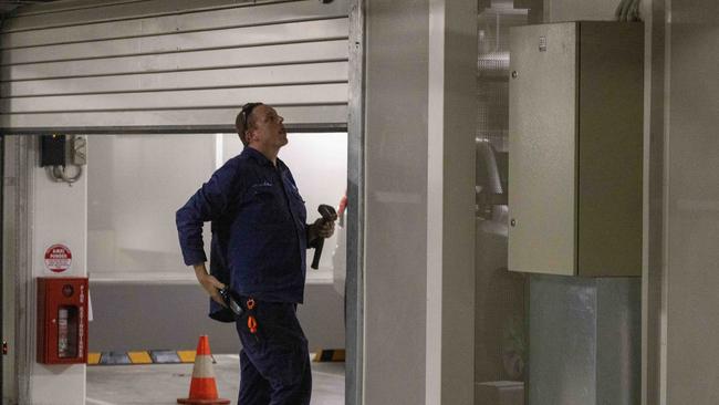 A repair man fixes the roller door to the Parliamentary car park after a car hit it but did not do major damage. Picture by Kelly Barnes