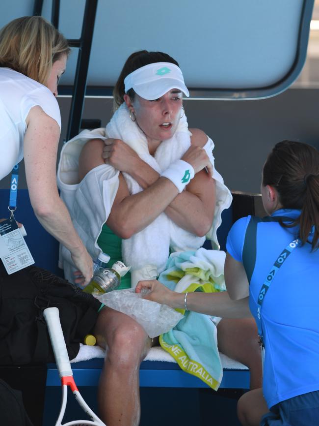 Alize Cornet of France is treated by medical staff. Photo: AAP