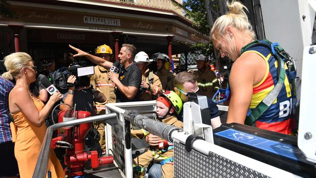 Mix 102.3 presenters Jodie Oddy and Mark Soderstrom welcome Alex and Crows AFLW star Erin Phillips as they return to the ground. Picture: Keryn Stevens