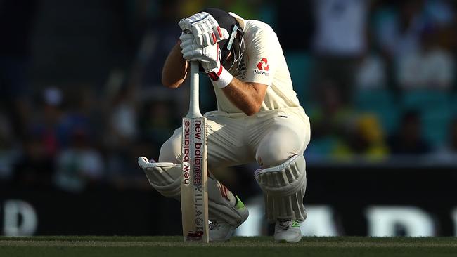 Joe Root slumps over his bat as he is caught for 83 at the SCG.