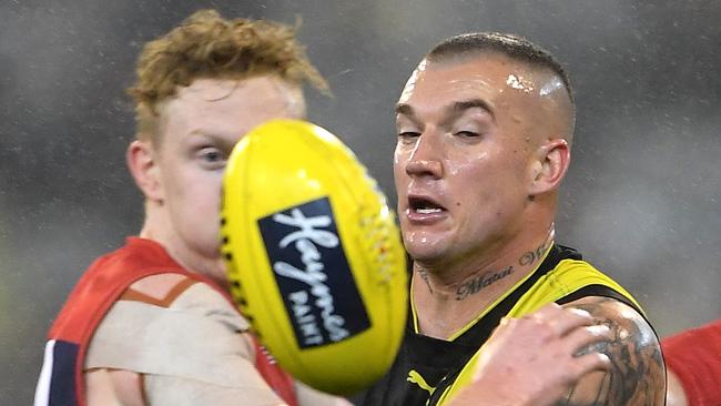 Clayton Oliver of the Demons (left) and Dustin Martin of the Tigers contest the Round 20 AFL match between the Melbourne Demons and the Richmond Tigers at the MCG in Melbourne, Saturday, August 3, 2019.  (AAP Image/Julian Smith) NO ARCHIVING, EDITORIAL USE ONLY