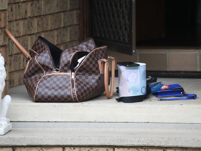 Some items found outside the house at Bonnyrigg today following the home invasion. Picture: David Swift