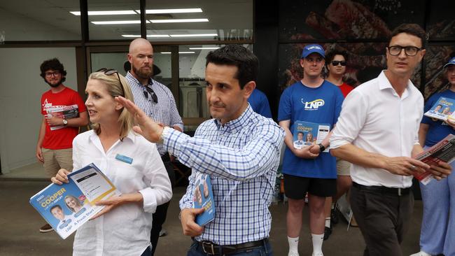 LNP candidate Amanda Cooper handing out how to vote cards with premier-elect David Crisafulli during the campaign as Labor Minister Bart Mellish watches on. Picture: Liam Kidston