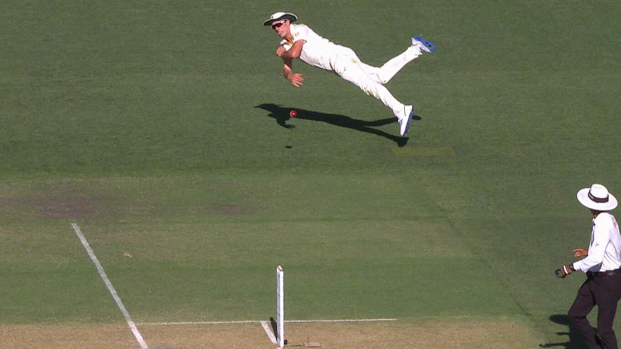 Pat Cummins throws the stumps down to dismiss Cheteshwar Pujara.