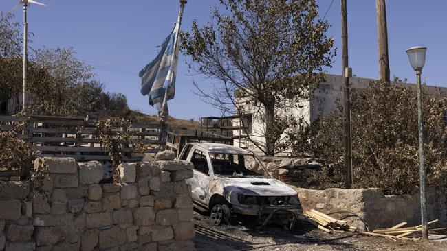 A burnt-out car sits on a driveway in Gennadi, Rhodes, Greece, which has been ravaged by wildfires. ‘If we look at things like what is going on in Europe this summer, things are speeding up,’ says Wendy Craik. Picture: Getty Images