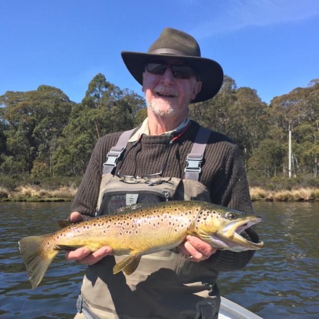 The late Jason Garrett a legendary Tasmanian fly fisherman with a prize catch.
