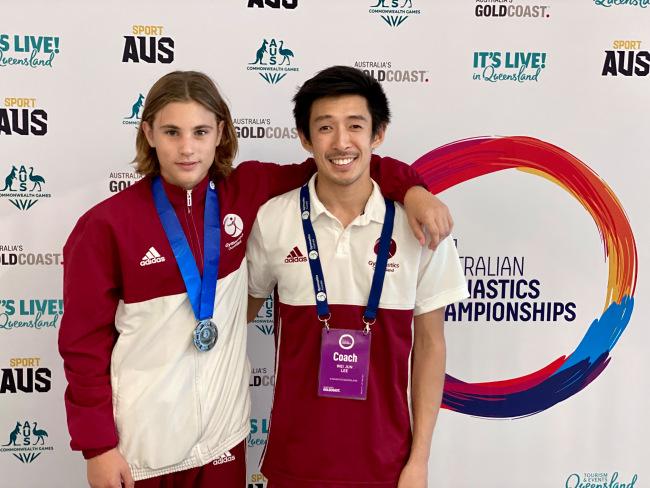 Joshua de Beer and his coach Wei Jun Lee from Skybound Gymnastics in Burleigh Heads.