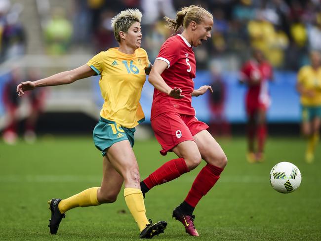 Quinn of Canada takes on Australian Michelle Heyman during a 2016 match. Picture: AAP Image/Lukas Coch