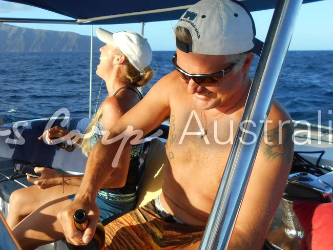 Good times on Shenanigans: John Nikolic pops the champagne while Yvette laughs with crew members. Picture: Jeff Hassell. 