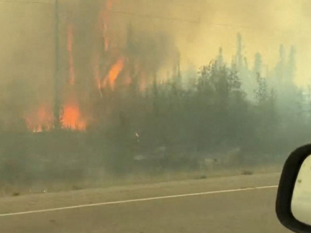 Flames threatened to engulf highways. (Photo by Jordan Straker / UGC / AFP)