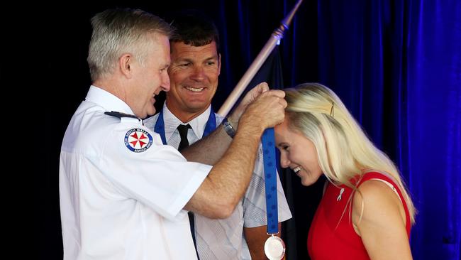 NSW Ambulance CEO Dominic Morgan presents an award to Steve Willdern and Angela Jay. Picture: Toby Zerna