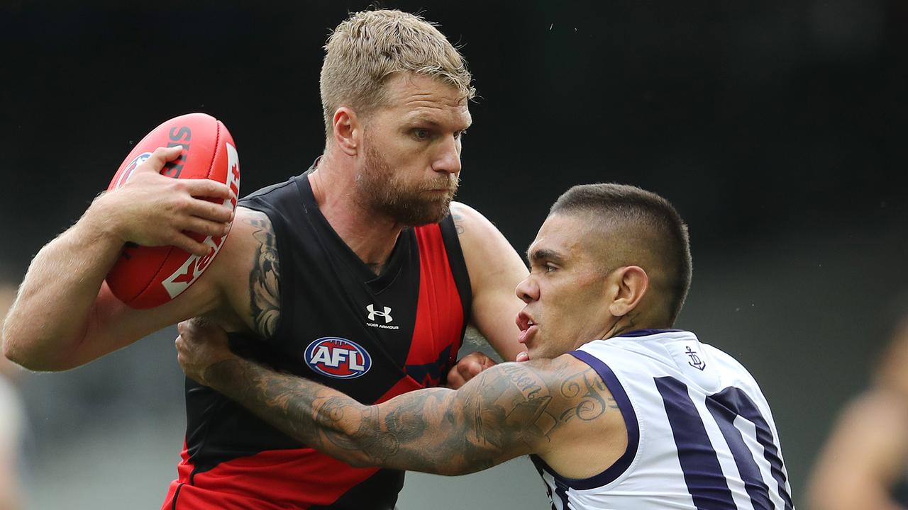 Essendon forward Jake Stringer tries to fends off Michael Walters. Picture: Michael Klein