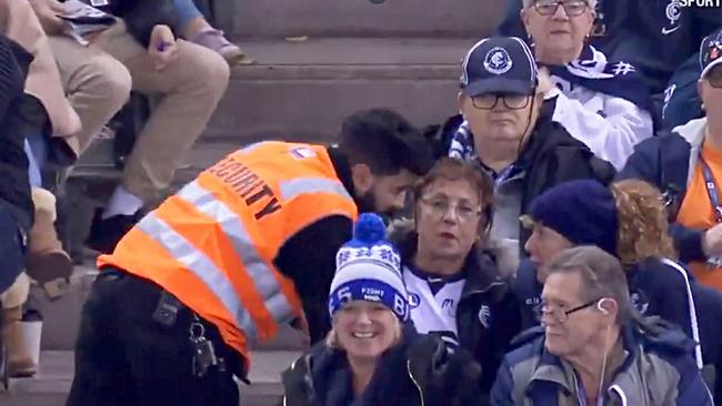 A security guard approaches Carlton fans at Marvel Stadium.