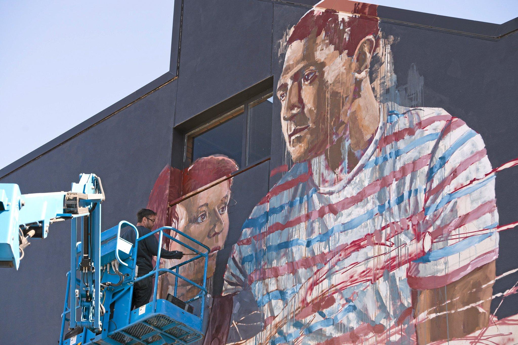 Fintan Magee paints on the SES building wall in Hume St car park for First Coat, Monday, May 30, 2016. Picture: Kevin Farmer