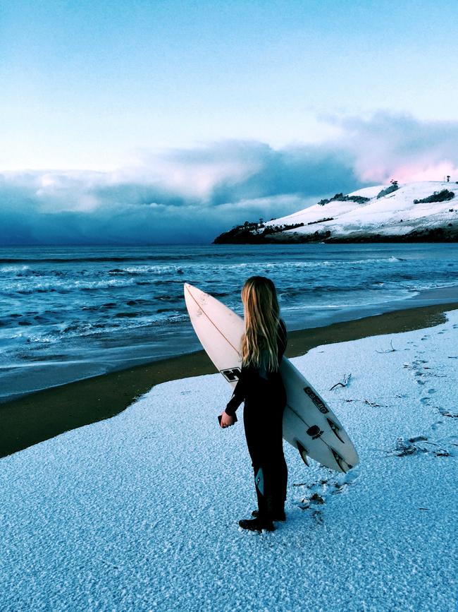 MUST CREDIT .. PAT FASNACHT.. Tabbi Fasnacht before heading out to surf at Clifton Beach this morning. She is my daughter and we were the first on the beach and went out surfing at Dawn. The coldest part was running through the snow to the water as the wetsuit boots have very thin soles. It was about 6.45am this morning. We surfed for an hour and a few other hardy souls also surfed at South Clifton - UPSIZED