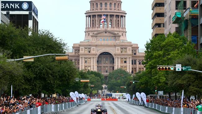 Daniel Ricciardo driving along North Congress Avenue backdropped by the Texas Capitol building in Austin Texas, as the city prepares for the US Grand Prix.