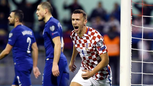 Croatia's midfielder Ivan Perisic (C) celebrates after scoring.