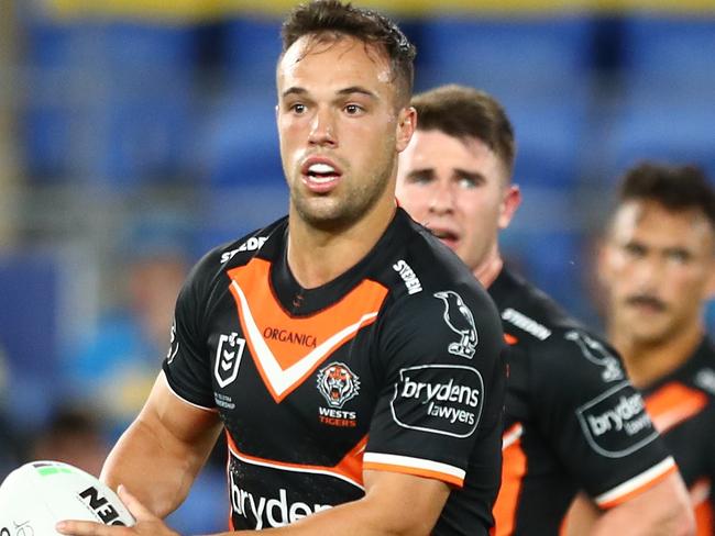 GOLD COAST, AUSTRALIA - MARCH 31: Luke Brooks of the Tigers passes during the round four NRL match between the Gold Coast Titans and the Wests Tigers at Cbus Super Stadium, on March 31, 2022, in Gold Coast, Australia. (Photo by Chris Hyde/Getty Images)