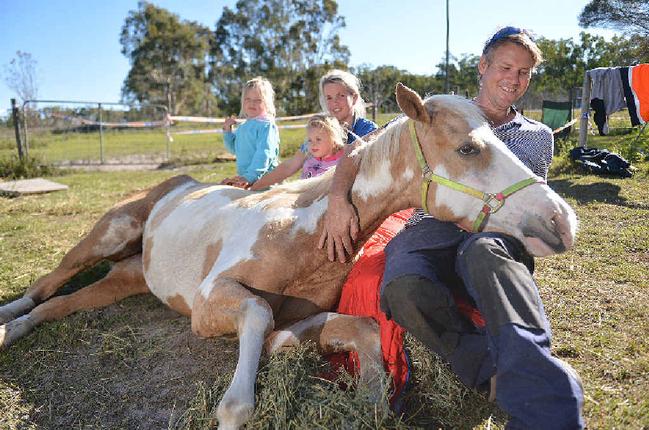 COMMUNITY HELP: Isabella and Sophie with the mum Gemma and Wayne Kerle, holding the slowly recovering Bella. Picture: Craig Warhurst