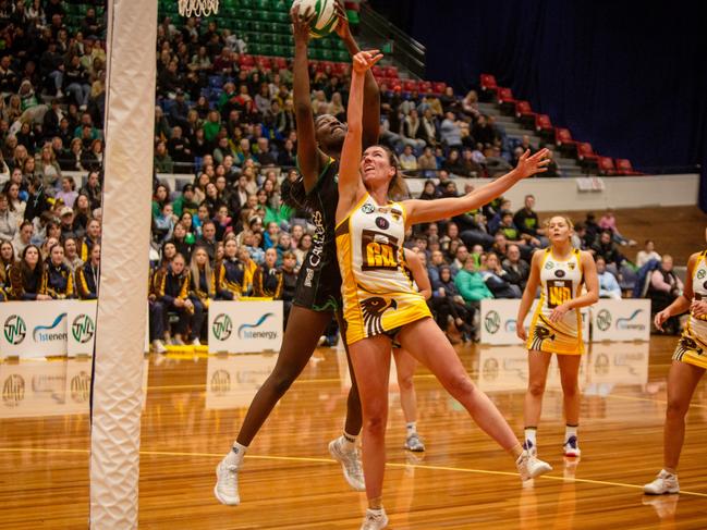 Cavaliers goal attack Esther Kidmas clashed in the air with Northern Hawks goal defence Tessa Coote in the grand final clash at Launceston's Silverdome. Picture: PATRICK GEE/SUPPLIED