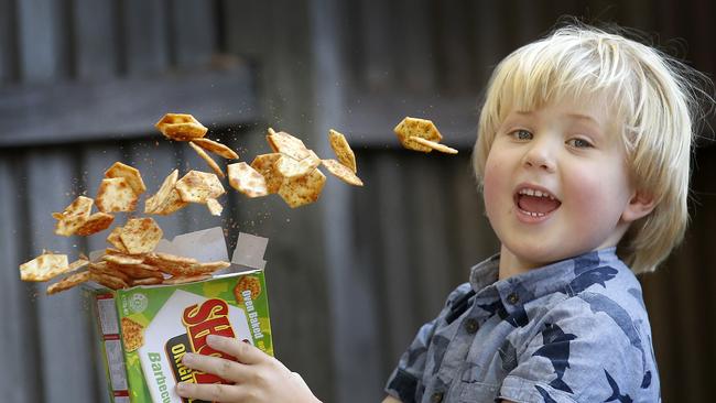 Alex 4, shakes up a box of his favourite snack, Barbecue Shapes. Picture: David Caird