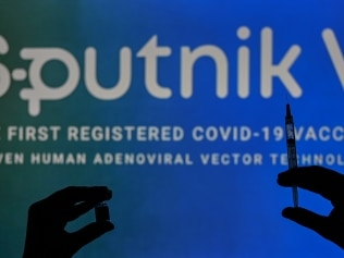 An illustrative image of a person holding a medical syringe and a Covid-19 vaccine vial in front of the the Sputnik V logo displayed on a screen. 
On Wednesday, January 12, 2021, in Edmonton, Alberta, Canada. (Photo by Artur Widak/NurPhoto via Getty Images)