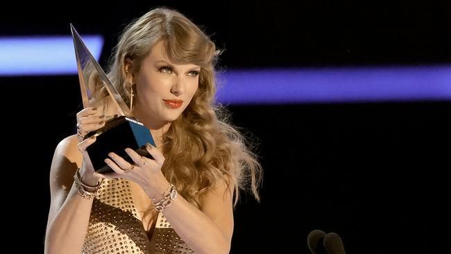 Taylor Swift, multi-award winner, is going head to head with the Kuranda Tree Frog. Taylor winning the Artist of the Year award onstage during the 2022 American Music Awards. Picture: Kevin Winter/Getty Images